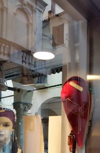 Feluca hat and buildings reflections on a shop window, Padova