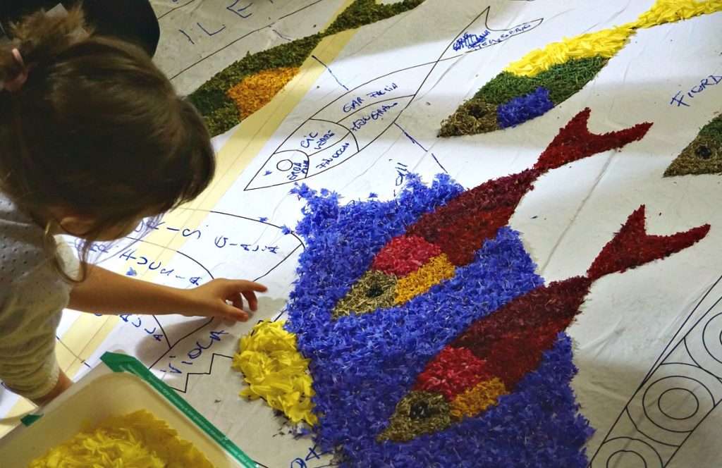 Little girl placing petals
